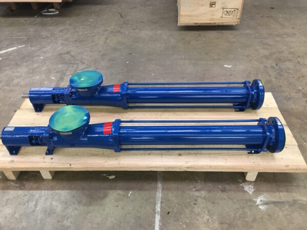 Two blue Fludyn BE2H mono pumps photographed crosswise on a wooden pallet