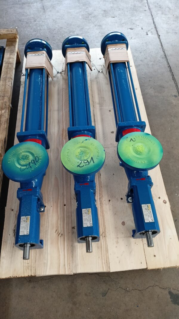 Three blue Fludyn E2H 1024 progressive cavity pumps without motors mounted lengthways on a light-coloured wooden pallet