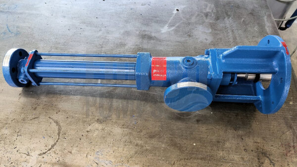 A blue painted Fludyn BE2L 164 progressing cavity pump / mono pump, without motor, lying crosswise on a metal table