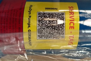 A yellow Fludyn service sticker. It shows a QR code for a special pump that can be used to order specific spare parts.